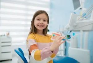 Young girl learning about dental health at the dentist in Parker, CO