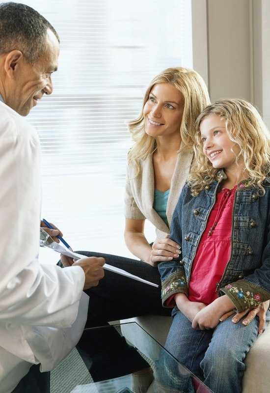 A male dentist is providing sedation dentistry solutions to a woman and her daughter in Parker, CO