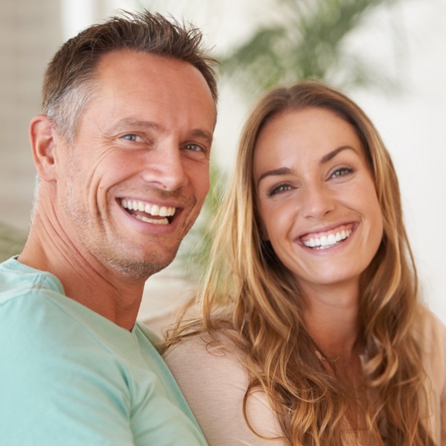 A couple is smiling happily after getting teeth whitening treatment in Parker, CO